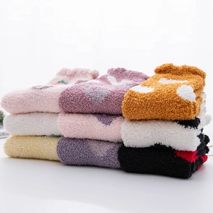 Detailed texture of colorful coral fleece winter socks with heart and dot patterns