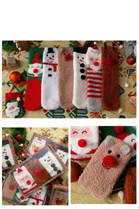 Detail of soft coral fleece Christmas socks featuring festive 3D reindeer and snowman designs