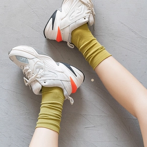 Women's mustard yellow ribbed slouch socks in velvet cotton blend styled with sneakers