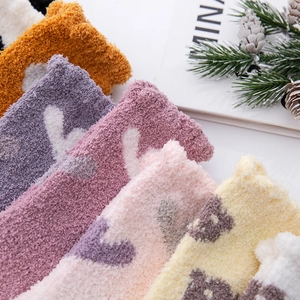 Close-up of thick coral fleece socks in candy colors with soft fuzzy texture