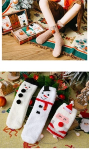Detailed view of fluffy Christmas coral fleece socks in a festive holiday gift set