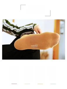 Detail of yellow cotton dress socks showing textured fabric and white printed sole markings