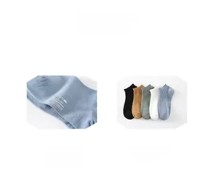 Detail of multi-color low-cut boat socks with printed washing icons and fine knit texture