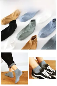 Close-up of ribbed cuffs on assorted solid color cotton ankle socks for men