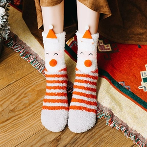 Plush Christmas coral fleece socks with 3D Santa Claus figure on festive stripe background