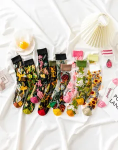 Detailed embroidery of vintage floral patterns on sheer mesh crew socks for women