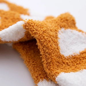 Close-up of thick ginger yellow coral fleece socks with soft chenille texture