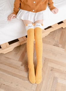 Thick coral fleece over-the-knee socks featuring a cute cartoon dog and fluffy texture