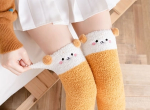Detailed view of yellow coral fleece thigh high socks with cute 3D animal ear design