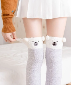 Detail of grey coral fleece over-knee socks with white bear ears and cute embroidery