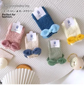 Detailed set of 5 thick coral fleece winter socks with 3D bows in warm home setting