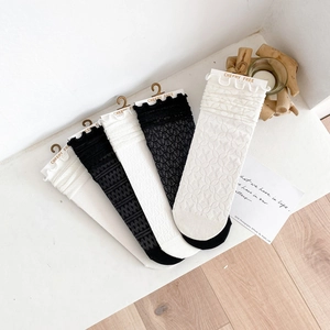 Detailed close-up of black and white mesh socks with ruffled wood fungus edges