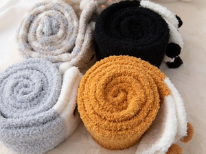 Detail showing four pairs of thick coral fleece winter socks in cute animal styles