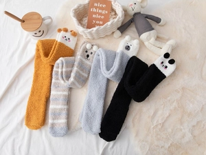 Detail of coral fleece thigh-high socks with cute 3D animal ears in various soft colors