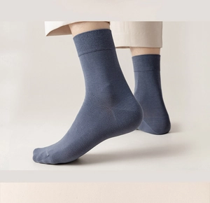 Detailed shot of men's blue ribbed cotton socks highlighting fit and elastic texture