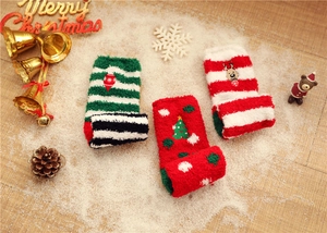 Detailed view of three festive thick coral fleece Christmas socks with reindeer embroidery