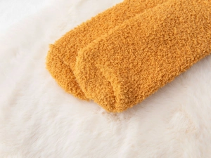 Close-up of thick ginger coral fleece socks showing soft textured plush fabric material