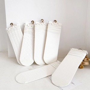 Set of six white cotton crew socks with mesh knit patterns and delicate ruffle trim