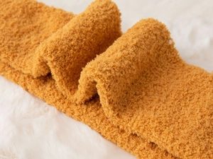 Detailed texture of thick yellow coral fleece socks with ultra-soft plush material