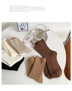 Detailed set of five ribbed cotton crew socks in neutral earthy tones on a white table