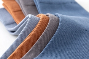 Detailed macro view of elastic ribbed cuffs on combed cotton mid-calf socks for men