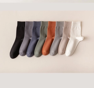 Detailed close-up of premium ribbed cotton socks in eight diverse solid neutral colors