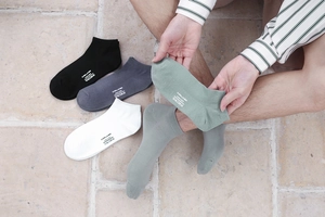 Close-up of assorted breathable cotton low-cut ankle socks with printed brand logo