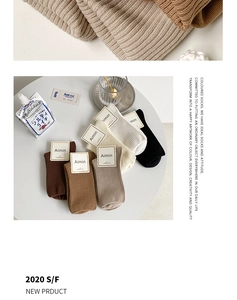 Detail view of ribbed cotton mid-calf socks in earthy tones with premium fabric texture