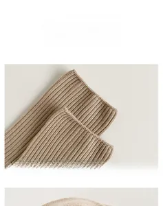 Detail display of oatmeal ribbed knit socks showing high-elasticity cuff texture
