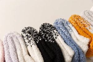 Nahaufnahme bunter Korallenfleece-Socken mit weicher Plüschstruktur und Mustern
