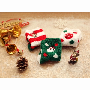 Three pairs of thick coral fleece Christmas socks featuring reindeer and Santa Claus embroidery