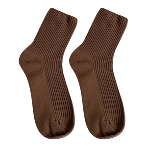 Deep chocolate brown ribbed knit crew socks for women featuring cozy vertical textures