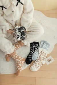 Detail of coral fleece socks with leopard print pattern for winter home comfort