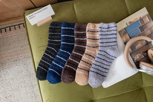 Close-up of five pairs of colorful striped coral fleece warm socks for winter