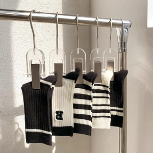 Detail of five cotton mid-calf socks with R letter embroidery and ribbed texture in black and white