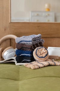 Close-up of thick striped coral fleece socks in grey, navy and khaki for home warmth