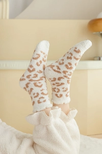 Close-up of leopard print coral fleece winter socks showing soft plush texture and pattern