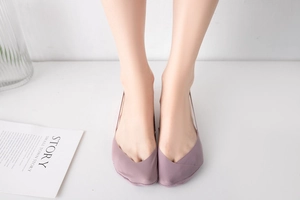 Detail of mauve seamless half-socks with V-cut design on foot in a modern lifestyle setting