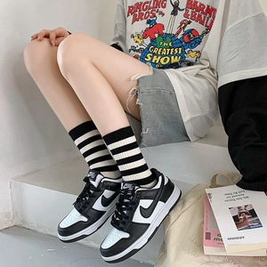 Striped cotton crew socks with embroidered detail paired with casual sneakers