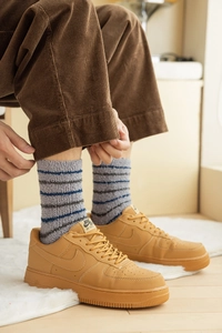 Close-up of men's thick coral fleece striped socks showing plush texture and warmth