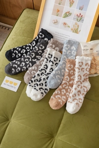 Detail of leopard print coral fleece socks in multi-color set for winter warmth