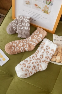 Close-up of leopard print coral fleece socks in grey, brown and cream tones