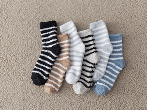 Macro shot of thick striped coral fleece socks in multiple colors with warm fuzzy texture
