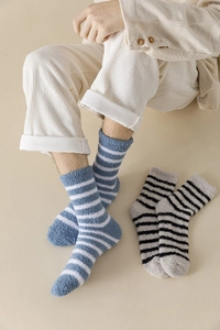 Detail showing plush striped coral fleece socks in blue, white and grey for home wear