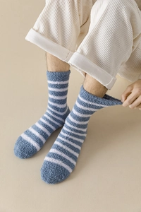 Close-up of blue and white striped coral fleece socks showing thick fuzzy texture