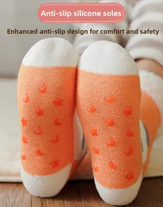 Close-up of non-slip silicone stars and moons on coral fleece socks for cozy home wear