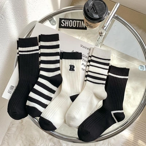 Minimalist black and white mid-calf socks with R letter embroidery and striped patterns