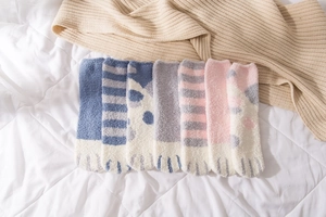 Detailed view of seven pairs of coral fleece cat claw socks in various soft pastel colors