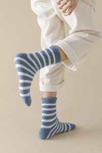 Close-up of blue and white striped coral fleece socks with thick thermal texture