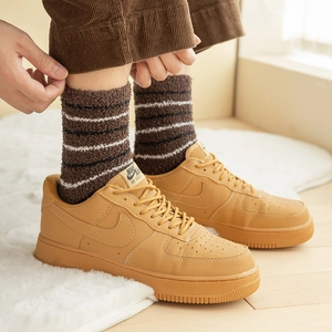 Thick striped coral fleece crew socks for men in coffee brown worn with sneakers